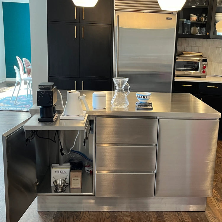 Modern kitchen with stainless steel appliances and island.